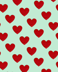 Pattern made of bold red heart shape on pastel green background. Cute minimal Valentine's day  inspiration for romantic Holiday.