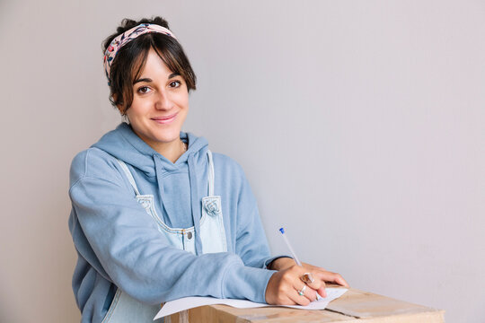 Young woman signing rent contract during relocation