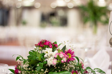 fresh colorful flowers in pink tonesin wedding table. flower background. space for text