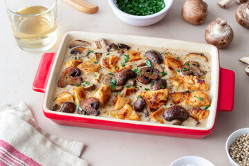 Baked chicken and mushrooms in a creamy sauce. French cuisine. Fricassee.