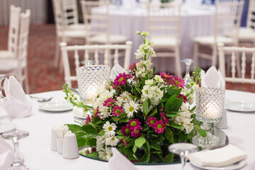 Fototapeta na wymiar wedding table decoration with fresh colorful flowers and candles