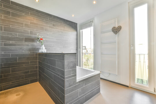 Interior of bathroom with built in tiled bathtub opposite window