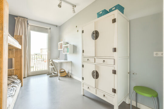 Interior of children room with wooden bunk bed and desk