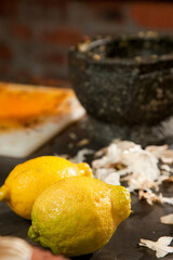 Lemons and other ingredients on a kitchen work surface.