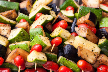 Vegetable skewer close-up. Fried on wooden sticks zucchini, cherry tomatoes, eggplant and bell peppers.