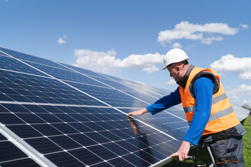 Solar power plant engineer makes a visual inspection of solar panels