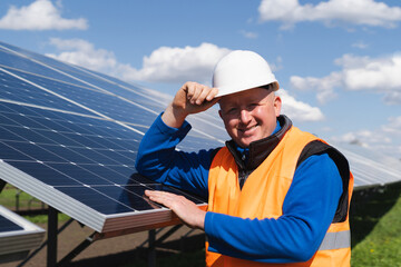 Portrait of a worker in hard hat at a solar power plant