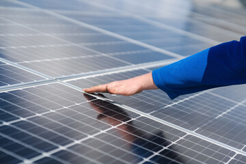 Engineer's hand on solar panel