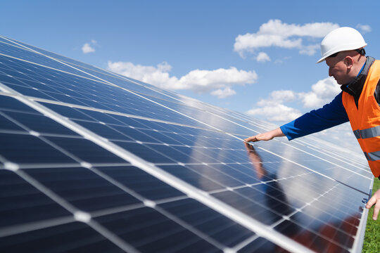 Solar power plant engineer makes a visual inspection of solar panels