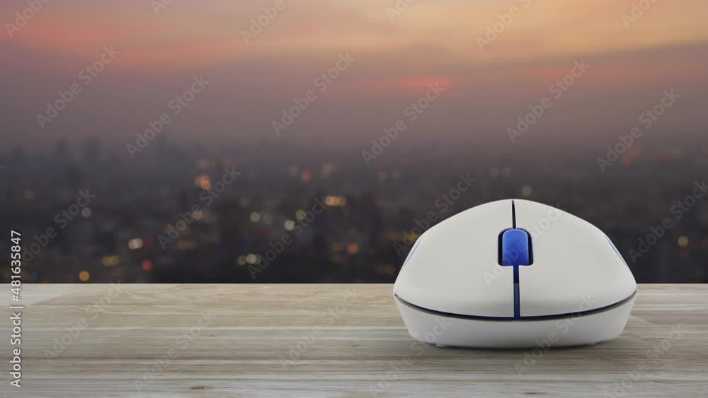 Poster padlock with shield flat icon with wireless computer mouse on wooden table over blur of cityscape on