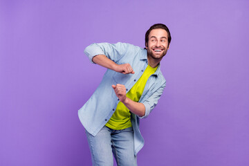 Photo of funky carefree male look copyspace dancing having fun laughing isolated on violet color background