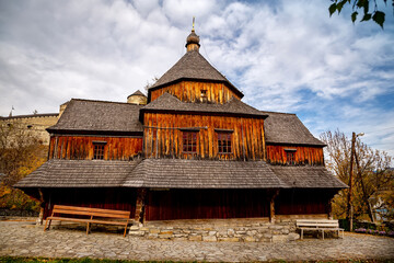 Fototapeta na wymiar Wooden church on an autumn day in Kamianets-Podilskyi.