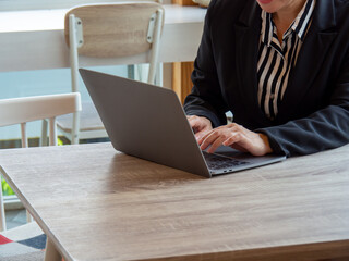 A woman using a laptop. Business office work.