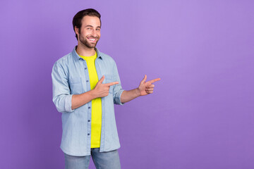 Photo of cheerful good mood man point finger copyspace advice promotion isolated on violet color background