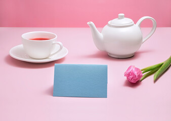 Mother's or woman's day tea and greeting card with copy space. Tea pot, card and pink tulip, tea party.