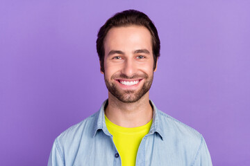 Photo of young handsome smiling man showing perfect white teeth stomatology isolated on purple...