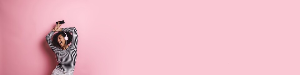 Cheerful young attractive african woman listening to music