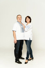 Fototapeta premium couple in embroidered shirts on a white background. people in national clothes of Ukraine on a white background.Cotton clothes with national ornaments