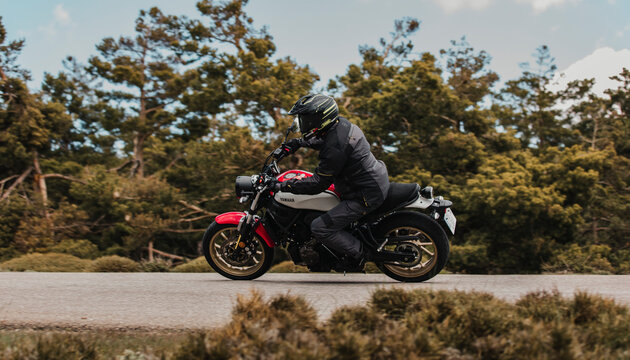 Calar Alto, Spain - May 5th 2021: Man riding fastly a Yamaha XSR700 motorcycle in a beautiful mountain range, during Dunlop Xperience event in Almería, Spain.