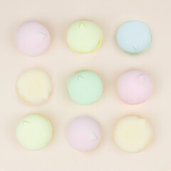 Obraz premium Marshmallows macaroons flat lay photo in minimal style. Top view, sweets and candy concept.