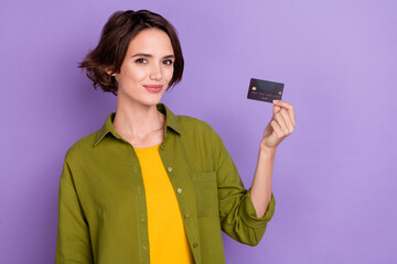 Photo of young pretty woman promoter show credit card earnings investment isolated over violet...