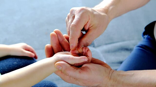 adult male hands holding kid hands, Family Help Care Concept, small hands in fathers hand, touching moment, touch of child and old man, grandfather, parents and child, adopted children, adoption