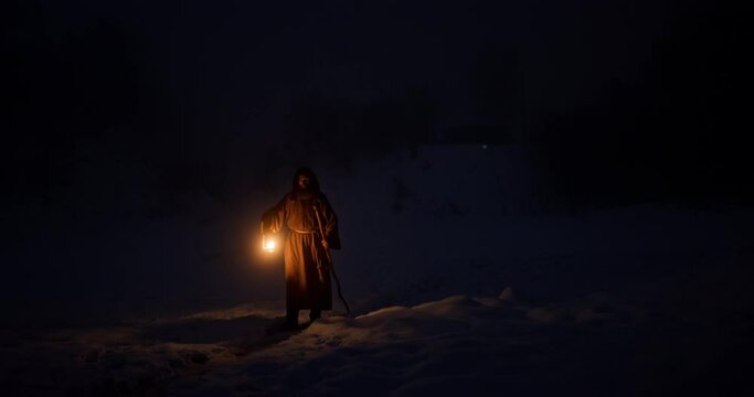 Hermit with lantern walking at night