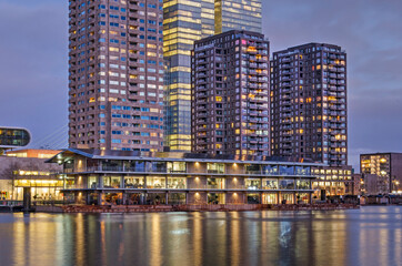 Rotterdam, The Netherlands, January 20, 2022: Rijnhaven harbour with the Floating Office and the Wilhelminapier highrise during the blue hour in the morning