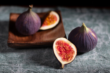 A few figs in a wooden plate