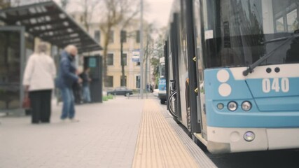 Person with a physical disability enters public transport with an accessible ramp