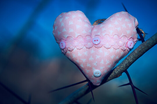 An image of a soft toy in the shape of a heart. Handicraft work.