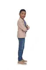 full portrait of boy with blazer looking at camera and arms crossed on white background © Curto