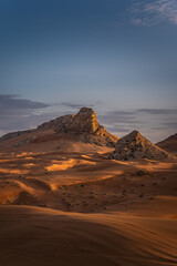 sand dunes and mountain at sunrise