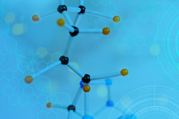 close-up of model of molecular compounds, deoxyribonucleic acid on a blue blurred background, study...