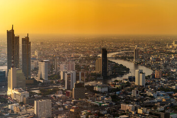 Modern Skyscraper of business center district at Bangkok skyline with sunset or sun rise sky background, Bangkok city is modern metropolis and favorite of tourists of Thailand