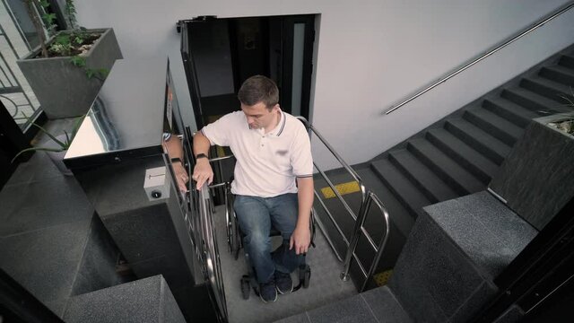 Special elevator for the person with a physical disabilities. A man in a wheelchair uses a special elevator