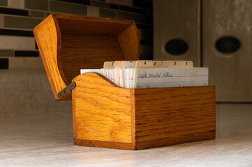 Wood recipe box on kitchen counter with hand written recipes 