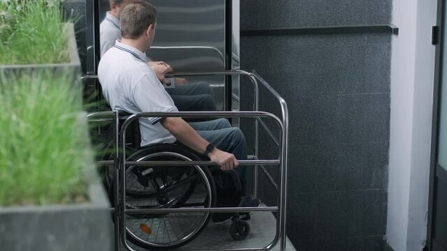 Special elevator for the person with a physical disabilities. A man in a wheelchair uses a special elevator