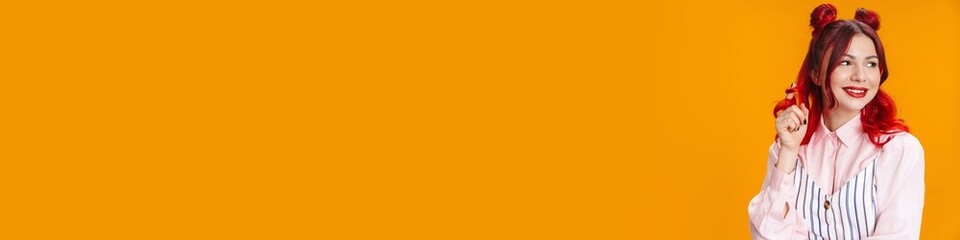 Happy girl with red hair smiling and looking aside