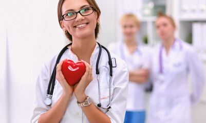 Doctor with stethoscope holding heart, isolated on white background