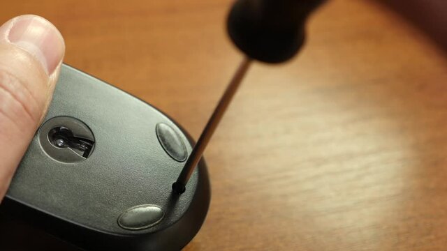 The wizard repairs the computer mouse. PC care and repair concept.