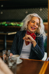 Smiling middle age woman at cafe