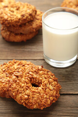 Peanut cookies with milk on grey background. Bakery products. Vertical photo