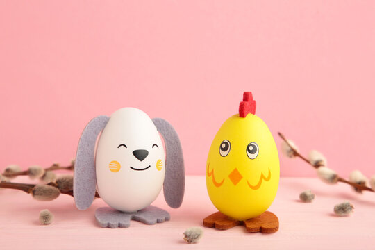 Easter holiday concept with cute handmade eggs, chicks and bunny on pink background.