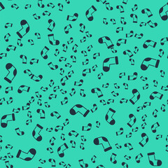 Black Christmas stocking icon isolated seamless pattern on green background. Merry Christmas and Happy New Year. Vector