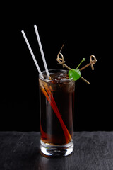 Alcoholic drinks at the bar. Bartender's hands in the process of making drinks.