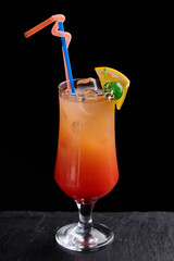 Alcoholic drinks at the bar. Bartender's hands in the process of making drinks.
