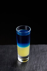 Alcoholic drinks at the bar. Bartender's hands in the process of making drinks.