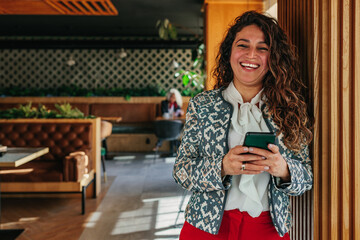 Young woman using cellphone indoors