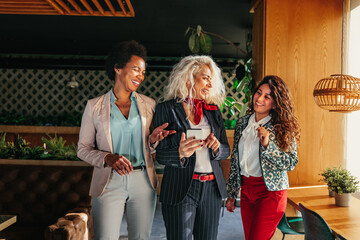 Three diverse businesswomen at cafe